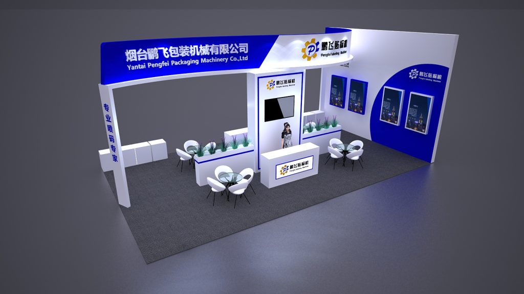 A white and blue exhibition booth viewed from above, showcasing a central counter with a person and screen, two small seating areas, and mounted product displays.