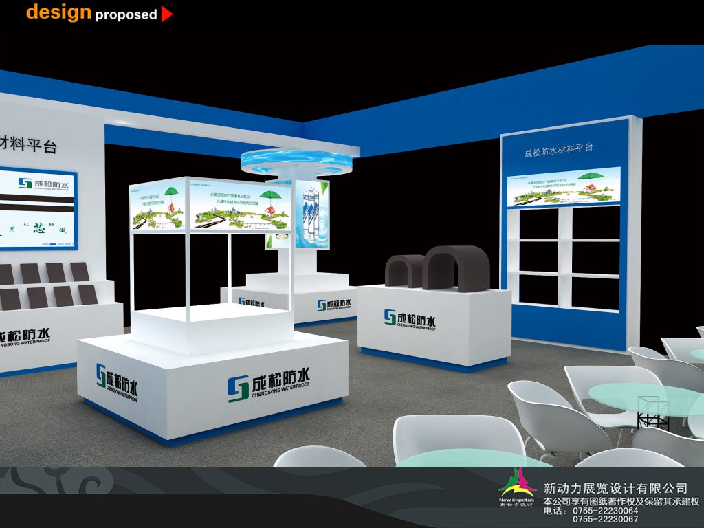 Inside a blue and white exhibition booth, featuring several white display pedestals with product images and light blue tables with chairs.