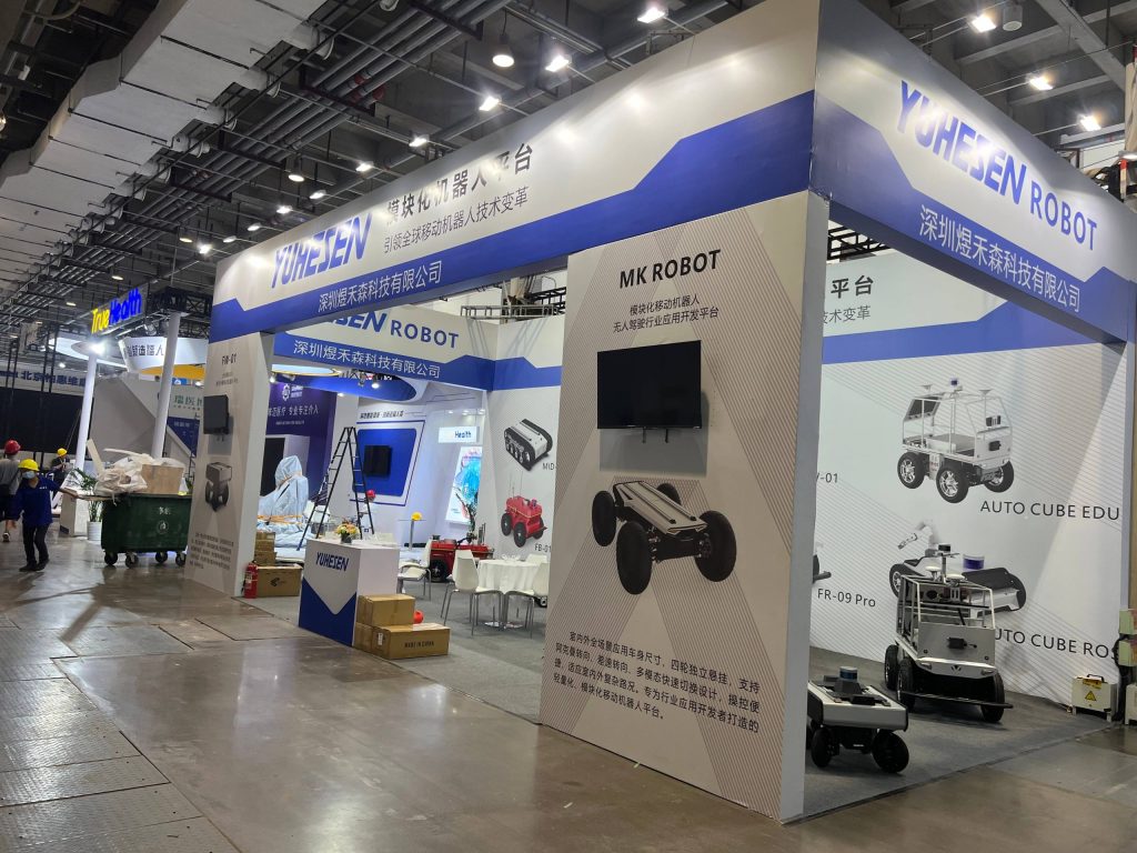 Side view of expo booth with robotic platforms and screens.