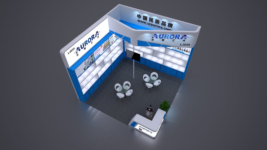 An overhead 3D rendering of a blue and white exhibition booth with display shelves, a reception counter, and two small tables with white chairs.