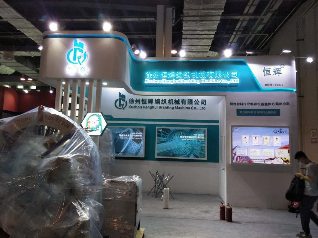 Trade booth with wrapped machines and a person.