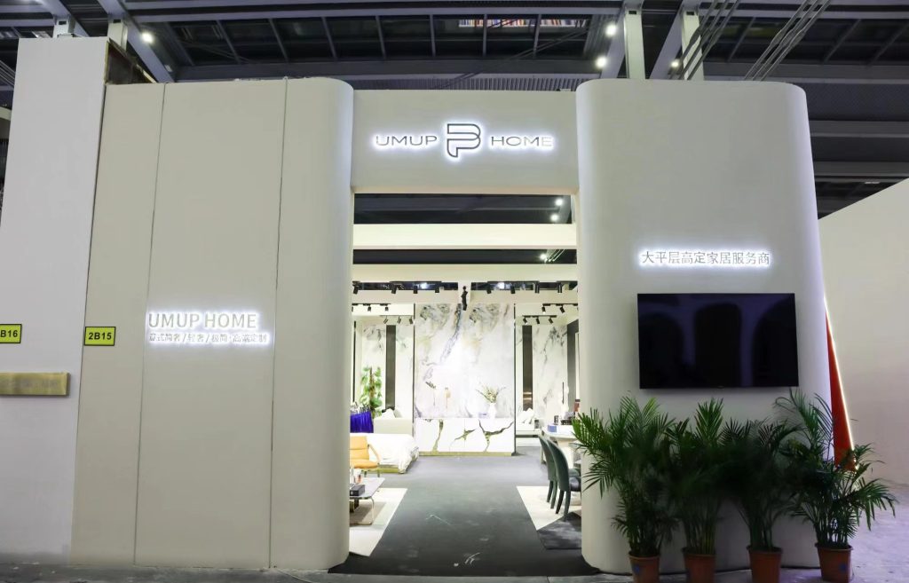 Booth entrance reveals furniture and decorative marble panels.
