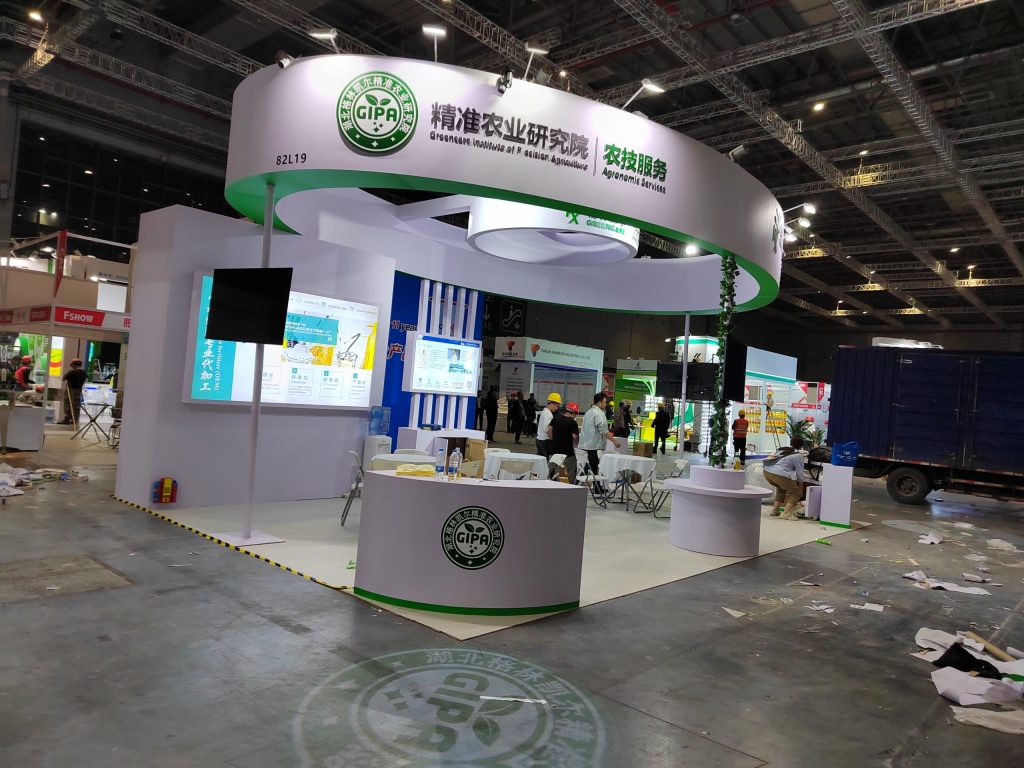 Trade show booth under construction, wide view with debris.