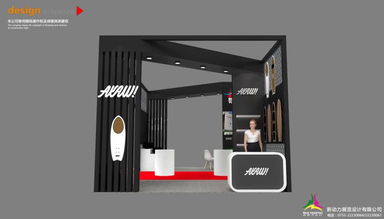 Close-up interior of a trade show booth, showing a white reception desk, a mannequin, and white slat walls with board displays.