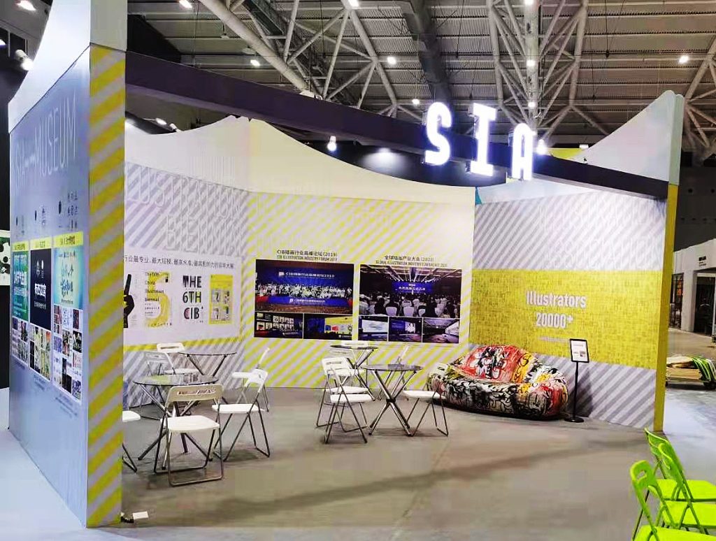 Booth with sofa, wall graphics, including "Illustrators 2000+".
