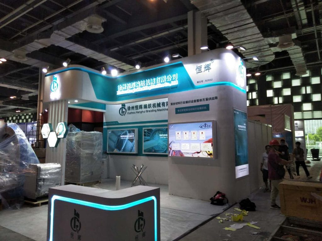 Trade booth with glowing counter and attendees.