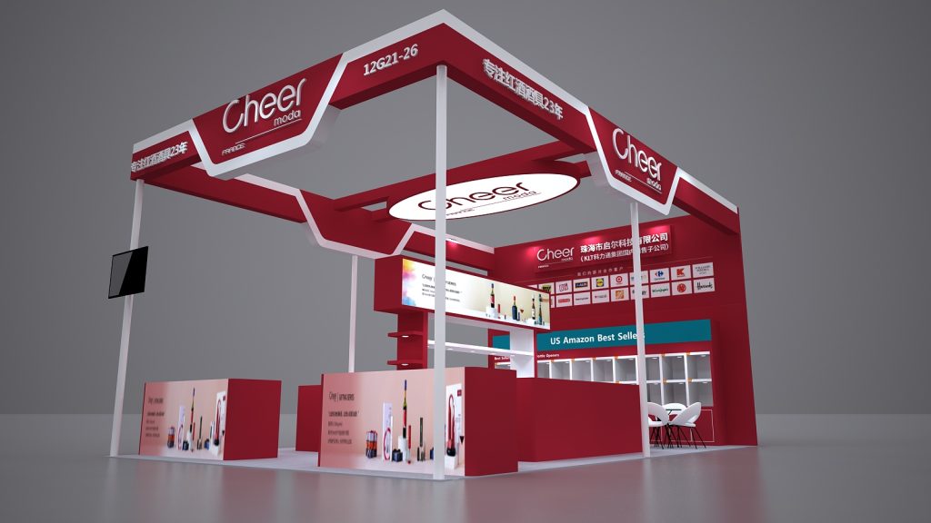 3D render of a modern red and white trade show booth with product displays, overhead signs, and a small seating area.