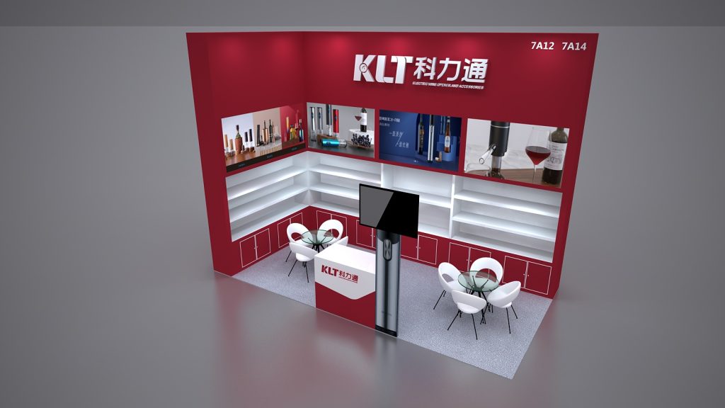 Overhead view of a red and white exhibition booth with product displays, a central monitor, empty white shelves, and two small white seating areas.