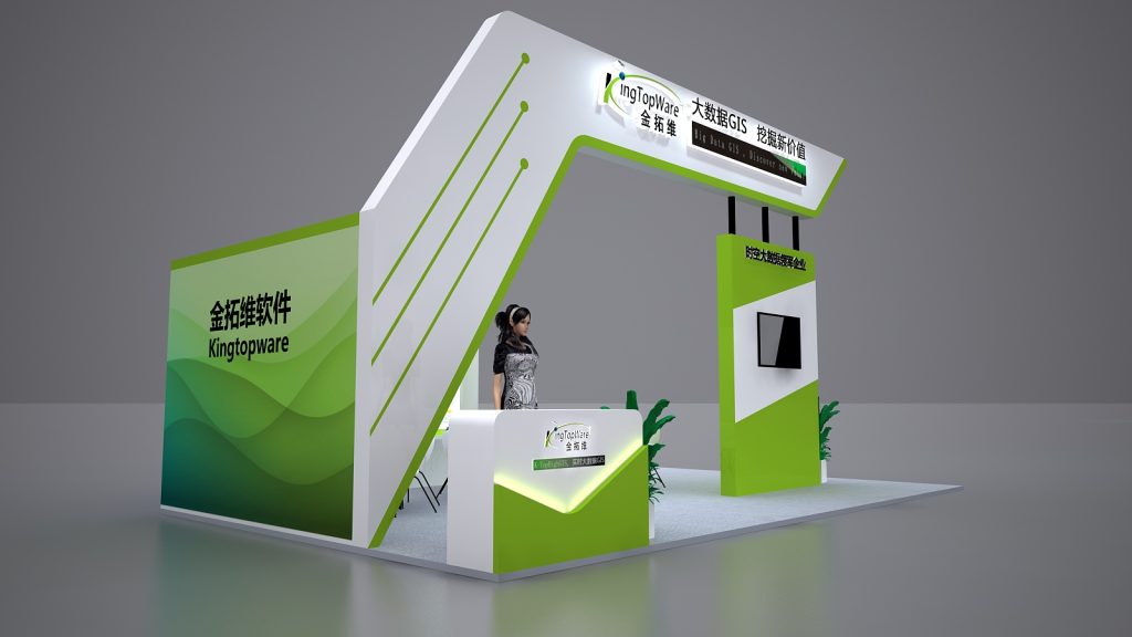 Side view of a green and white exhibition booth. It features an arched frame, a reception desk with a mannequin, display panels, and a mounted screen.