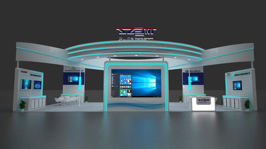 Front view of a white, futuristic trade show booth with blue accent lighting. A large central screen shows a Windows desktop, flanked by smaller screens and seating.