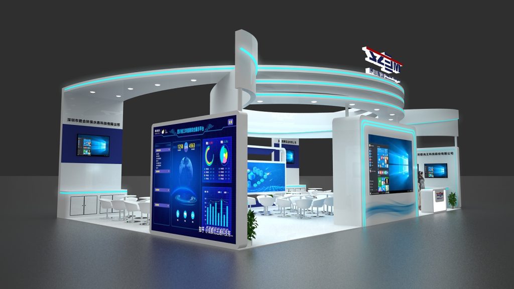 Interior view of a high-tech exhibition booth with blue accents. Large display screens show data dashboards, charts, and a globe. White tables and chairs are arranged for visitors.