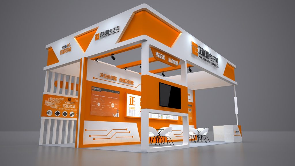 Render of an orange and white trade show booth featuring an empty large screen, display panels, and several white tables with chairs.