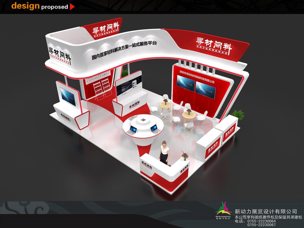 Overhead view of a red and white exhibition booth. It includes interactive displays, screens, multiple counters, and seating areas with a woman in the center.