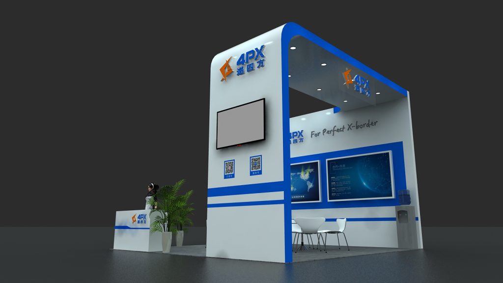 White and blue exhibition booth with a main display screen, two QR codes, and a reception desk with a plant. A seating area with two chairs is inside.