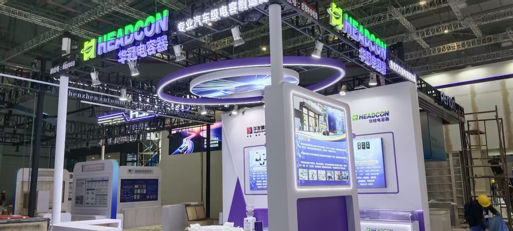 Close-up of booth, large screen, product models, circular light.