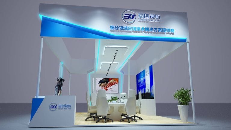 3D render of a modern white and blue exhibition booth interior with a conference table, chairs, and display screens.