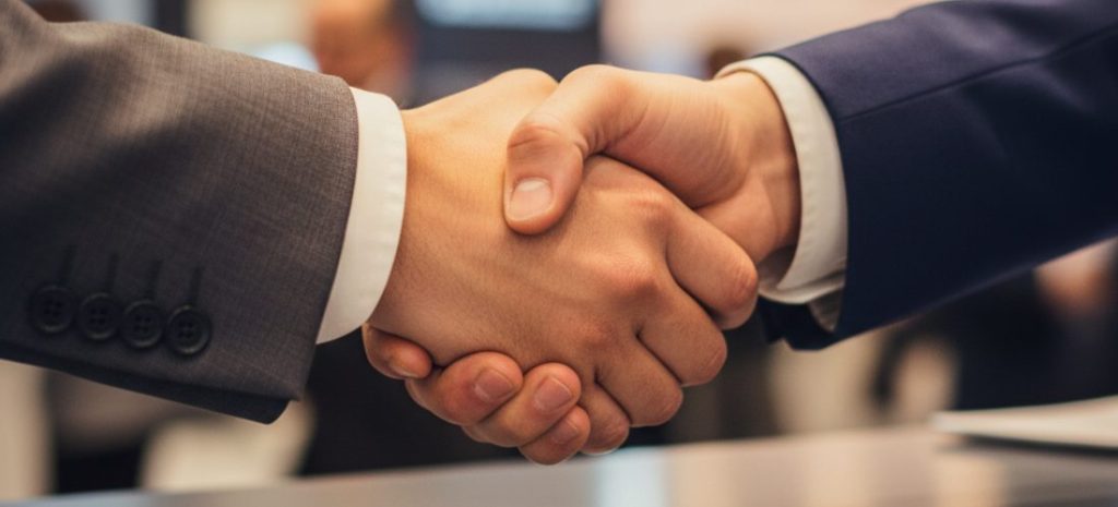 handshake between exhibitor and client at trade show booth, overlay of subtle digital pipeline flow or conversion arrows, sense of progression from conversation to deal, warm lighting, realistic, cinematic, professional business style