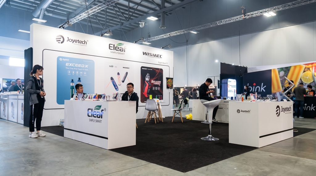 new zealand exhibition booth builder NeoBooths designed Joyetech Eleaf Wismec e-cigarette vape brand stand at Auckland New Zealand trade fair with three-counter layout and customer demo area