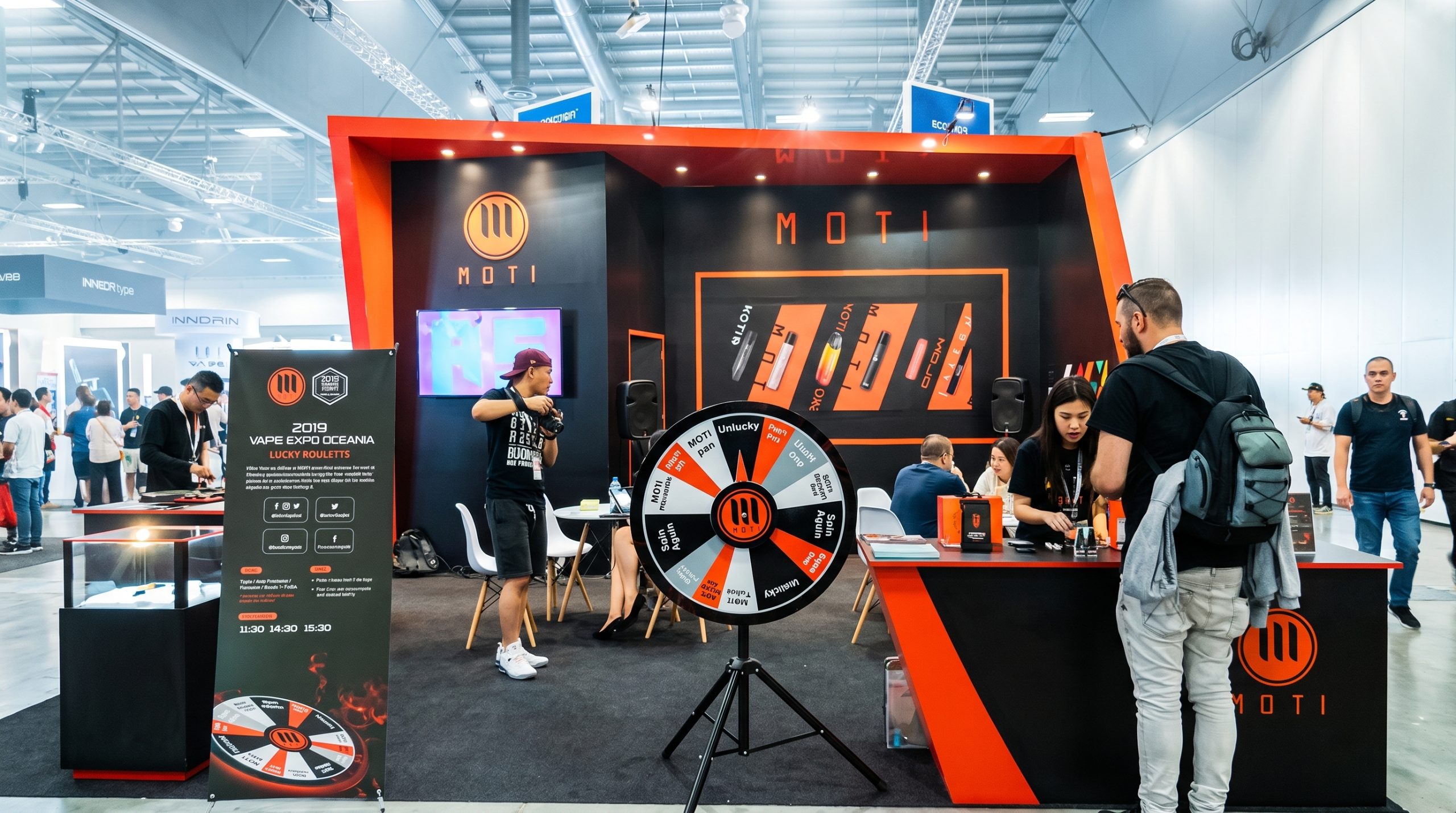 uae exhibition booth builder NeoBooths designed MOTI vape e-cigarette brand stand at Dubai World Trade Centre with lucky roulette interactive game and black-orange wall at uae vape expo