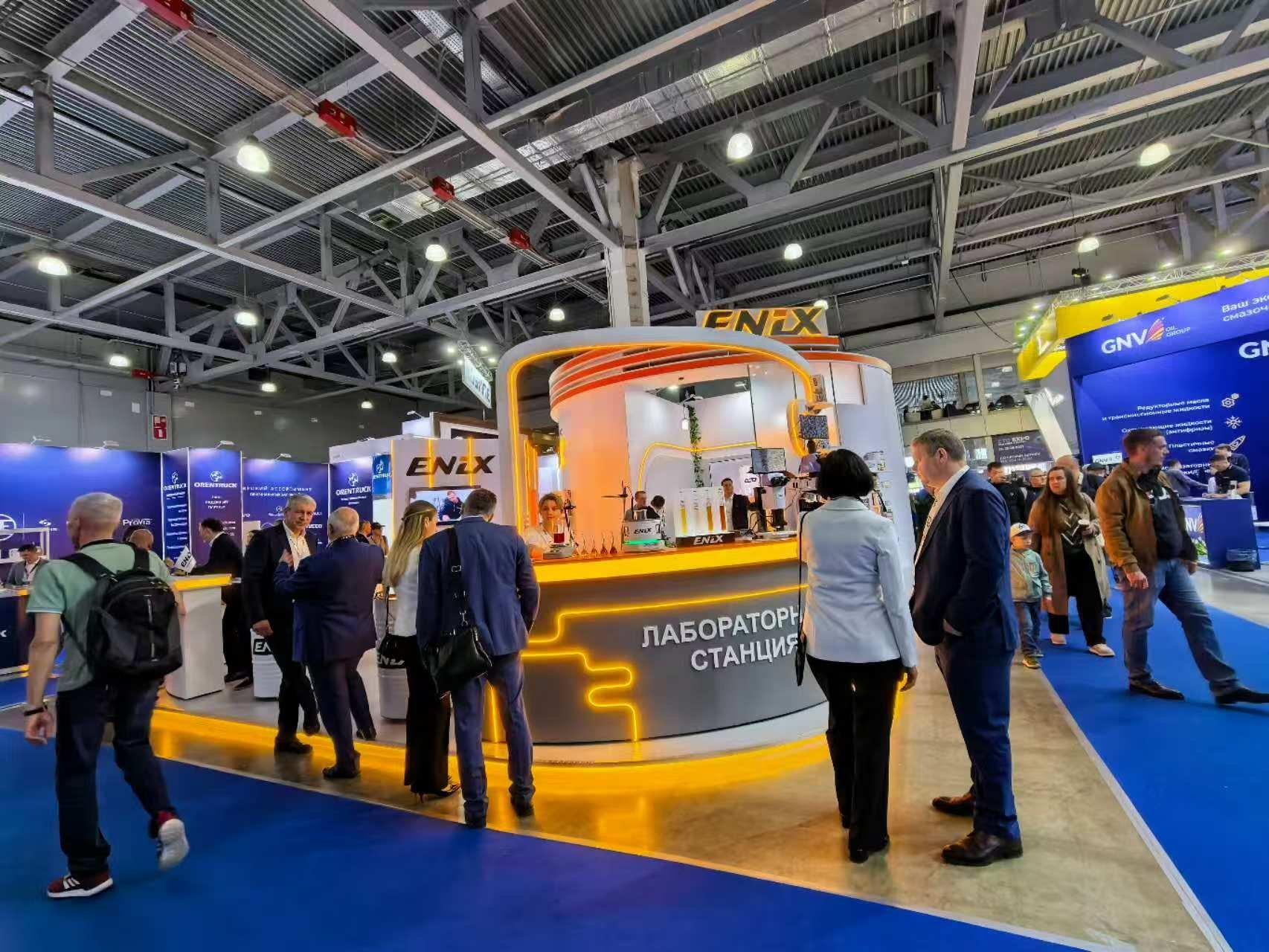 oval exhibition stand with illuminated reception counter at a Russian trade show