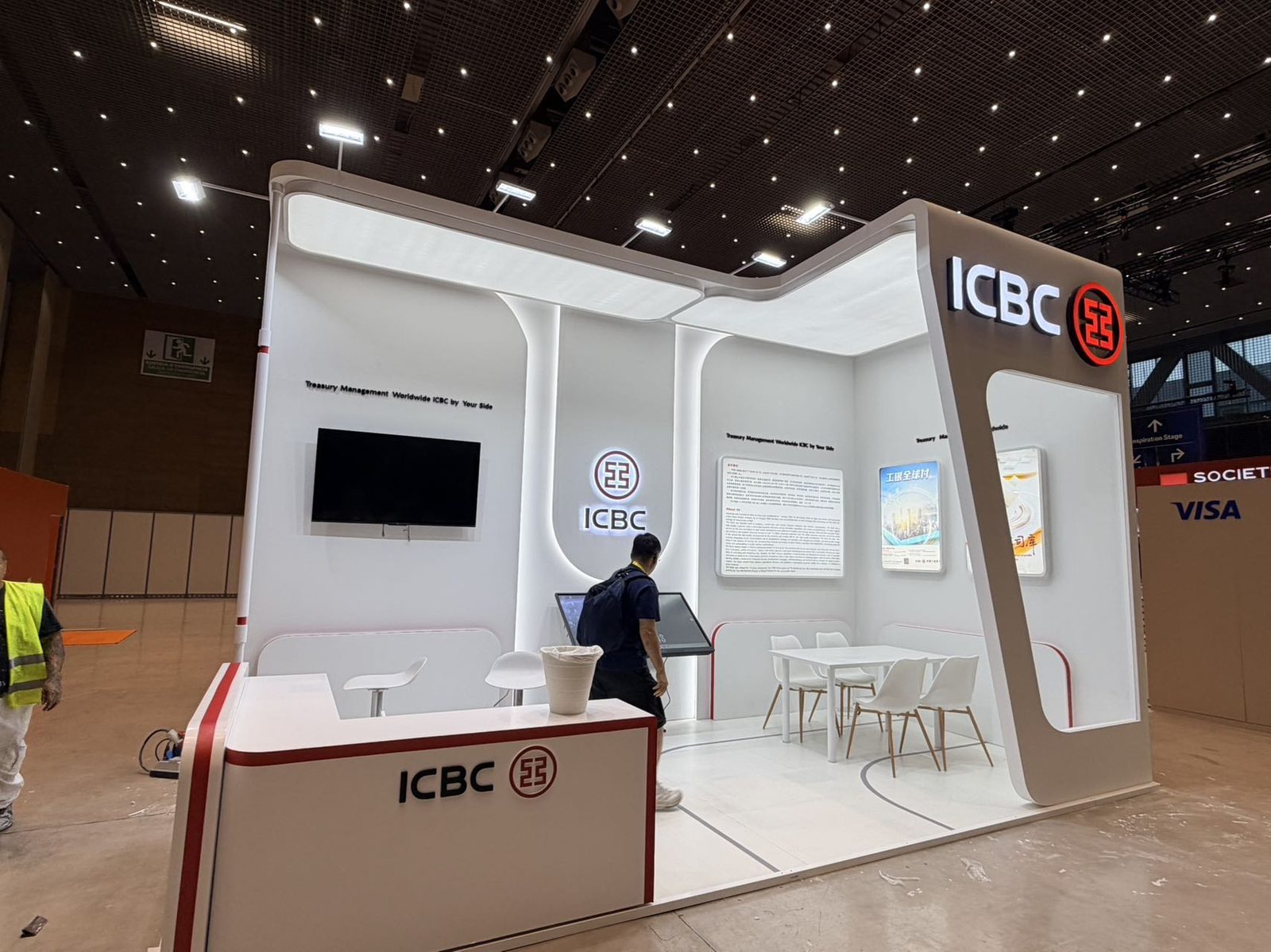 exhibition stand with curved logo tower during build-up at a Spanish venue