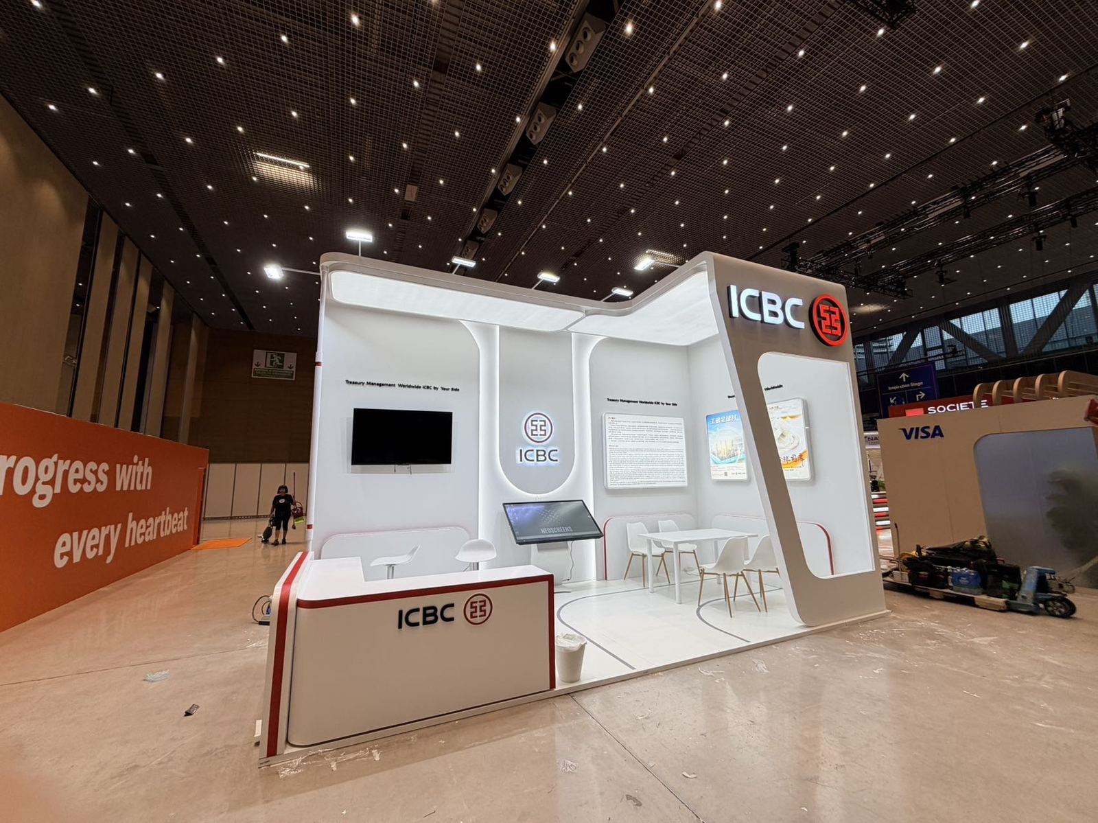 custom exhibition booth with reception counter and meeting area in Spain